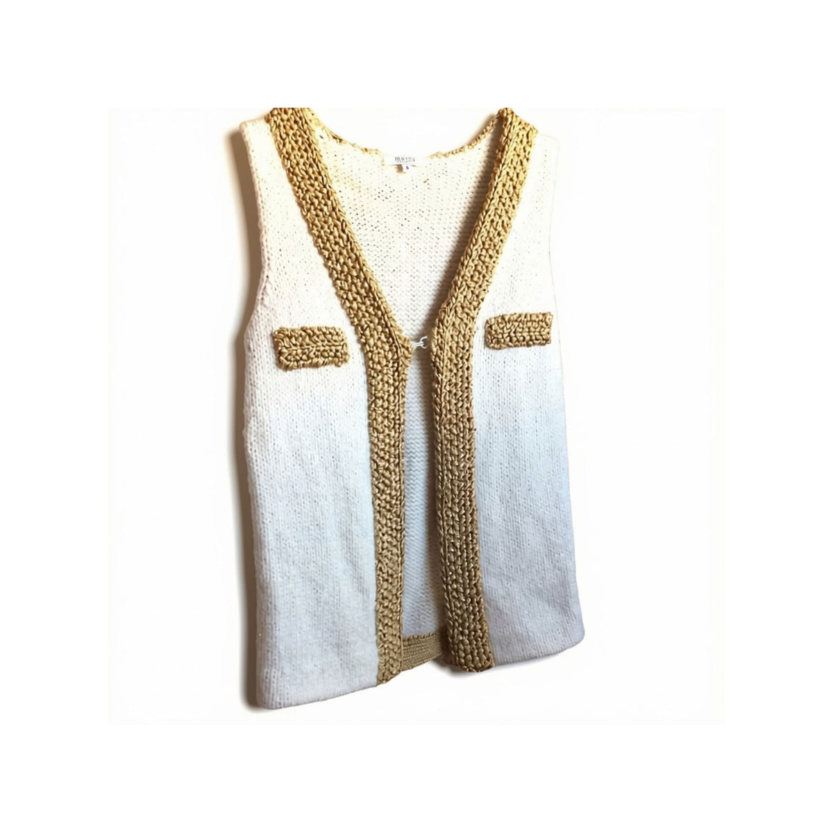 A sleeveless knit vest with a white to light gray ombré body and prominent tan/golden-brown braided trim along the V-neck, front opening, and two chest pockets, shown on a plain white background.