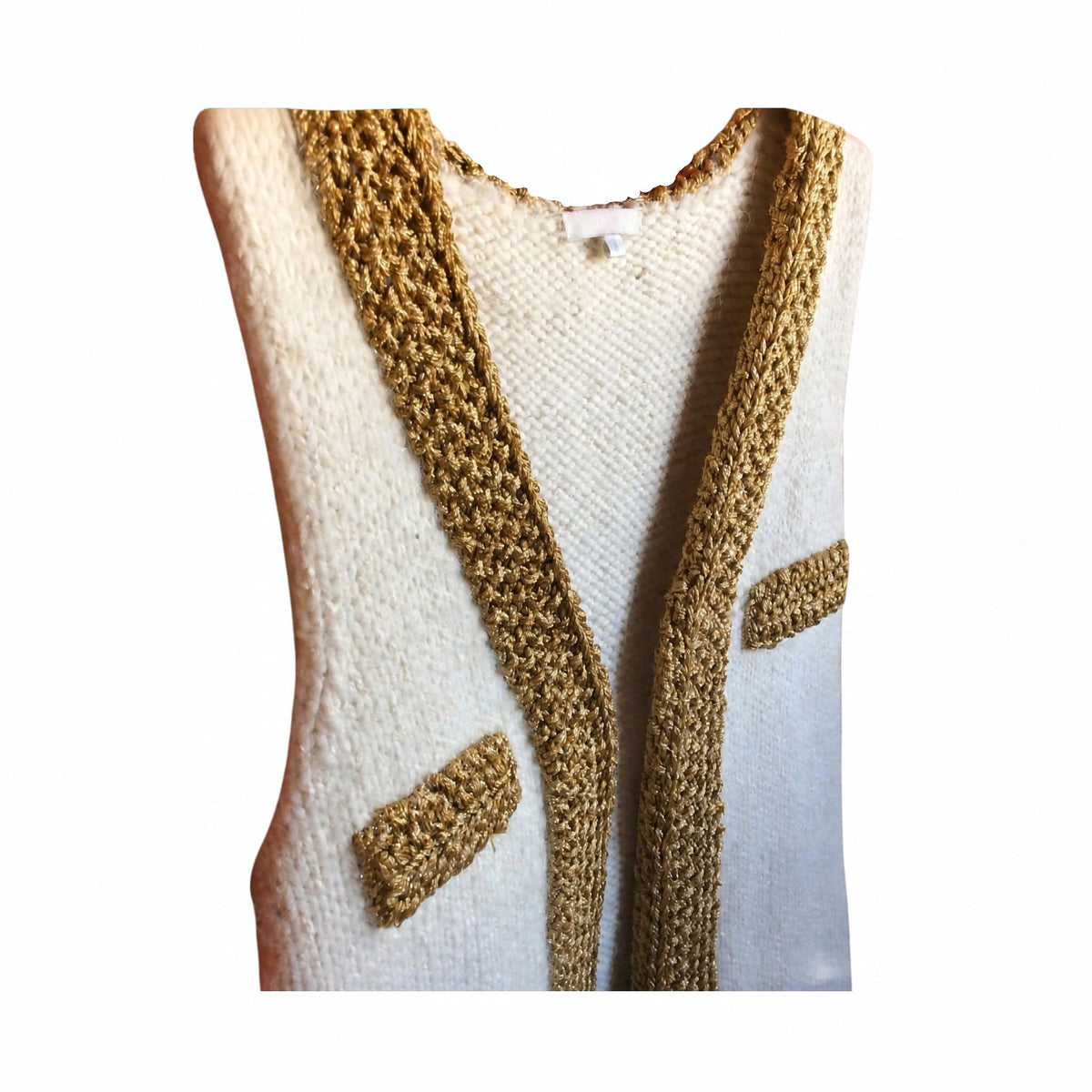 A cream-colored knit vest with prominent textured mustard-gold trim along the open front and two matching chest pockets, shown against a plain white background.