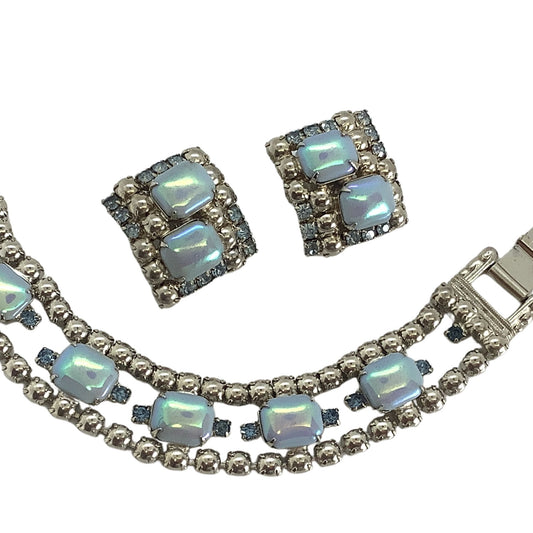 Jewelry set with necklace and earrings featuring blue moonstones on a white background