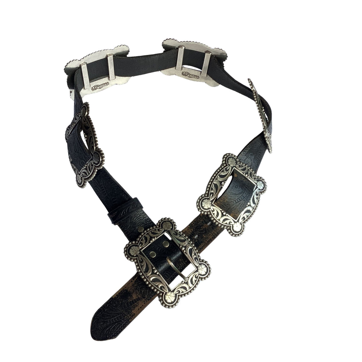 Nocona black leather belt with ornate silver-toned metal buckles and decorative silver conchos, displayed on a clean white background.