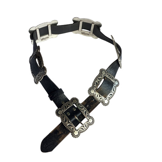 Nocona black leather belt with ornate silver-toned metal buckles and decorative silver conchos, displayed on a clean white background.