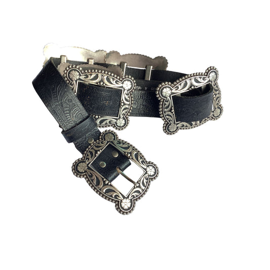 Nocona black leather western-style belt with ornate silver-tone metal buckles and decorative engraved details, shown on a plain white background.