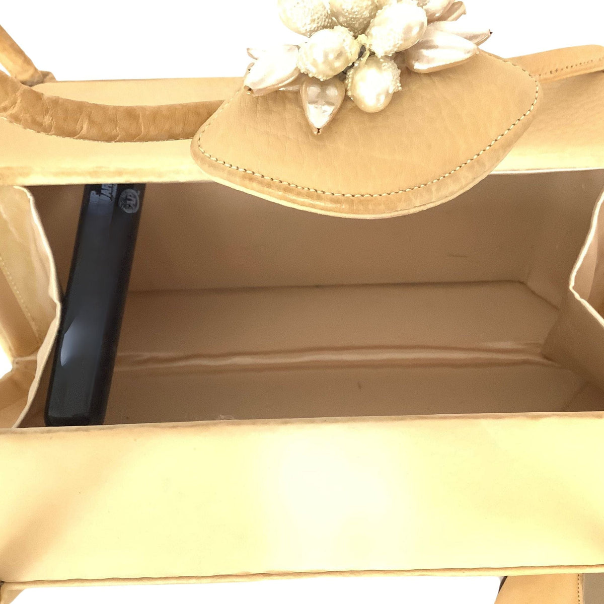 Palizzio yellow handbag with cluster pearl adornment, interior view.