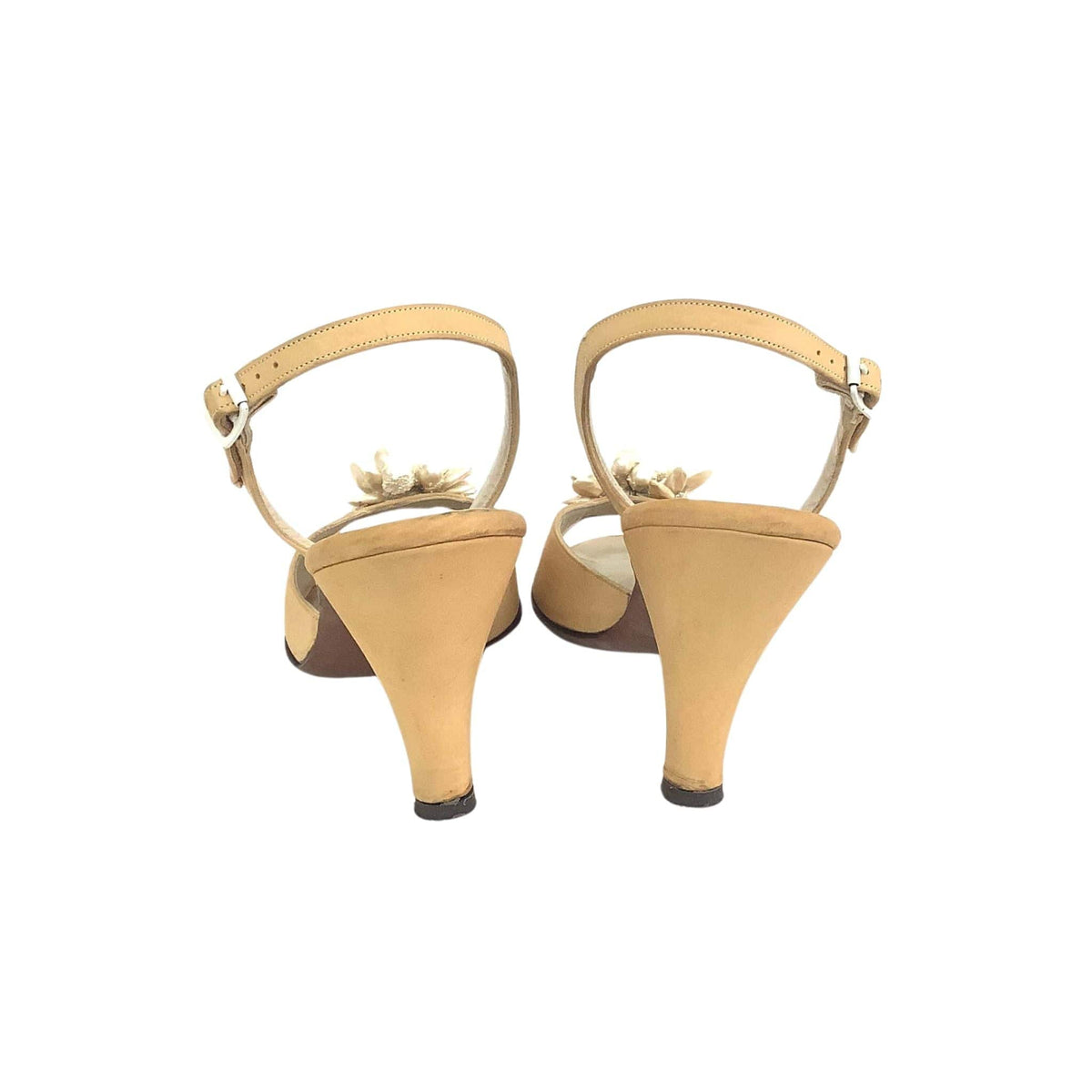 A pair of yellow Palizzio slingback wedge heels with a small floral embellishment on the strap, shown from the back against a plain white background.
