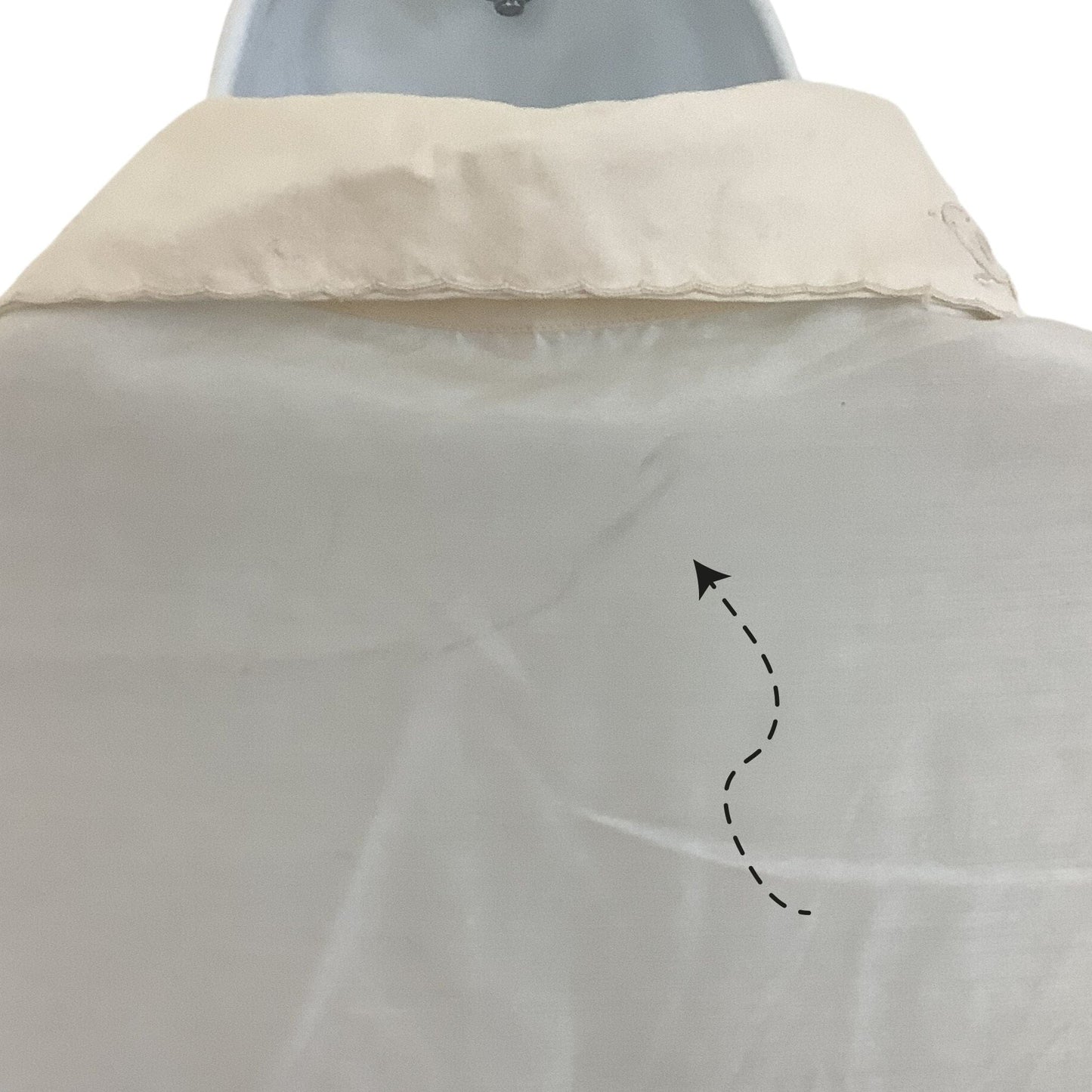 back of silk blouse with arrow pointing to stain 