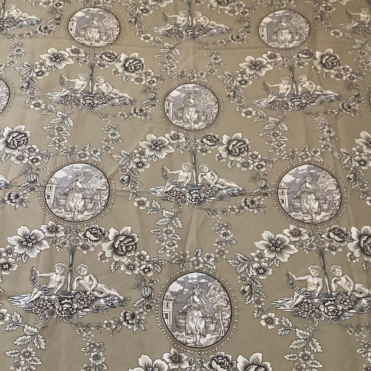 Vintage brown fabric with a classic toile pattern featuring circular medallions of classical figures, floral motifs, and pastoral scenes in muted gray and brown tones.