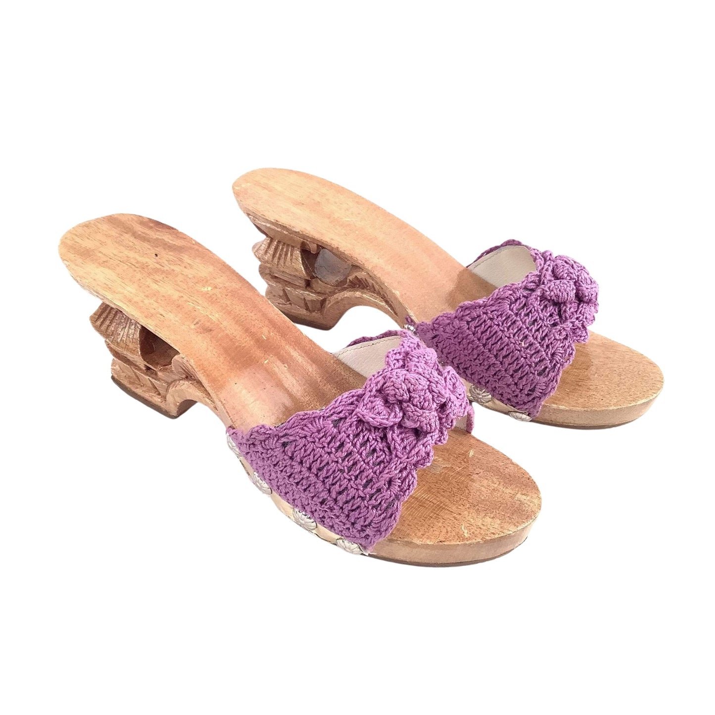 Wooden sandals with purple crochet straps on a white background