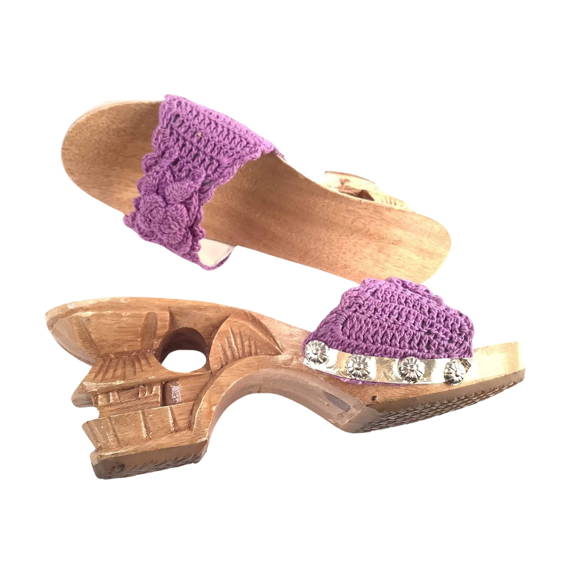 Wooden sandals with purple crochet straps heel detail on a white background