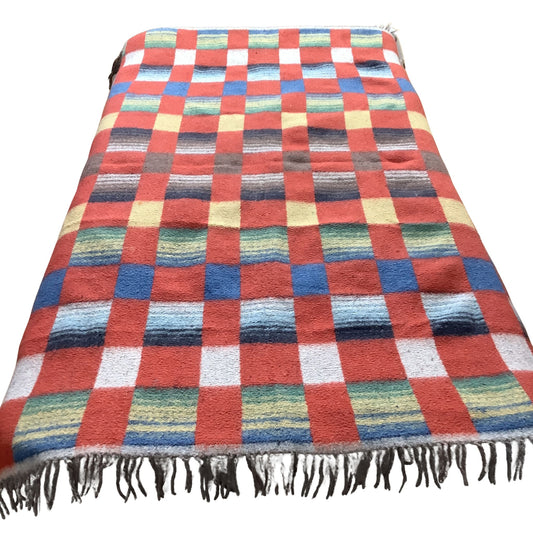 Overview of a vintage blanket in a red-multicolor checkered pattern.