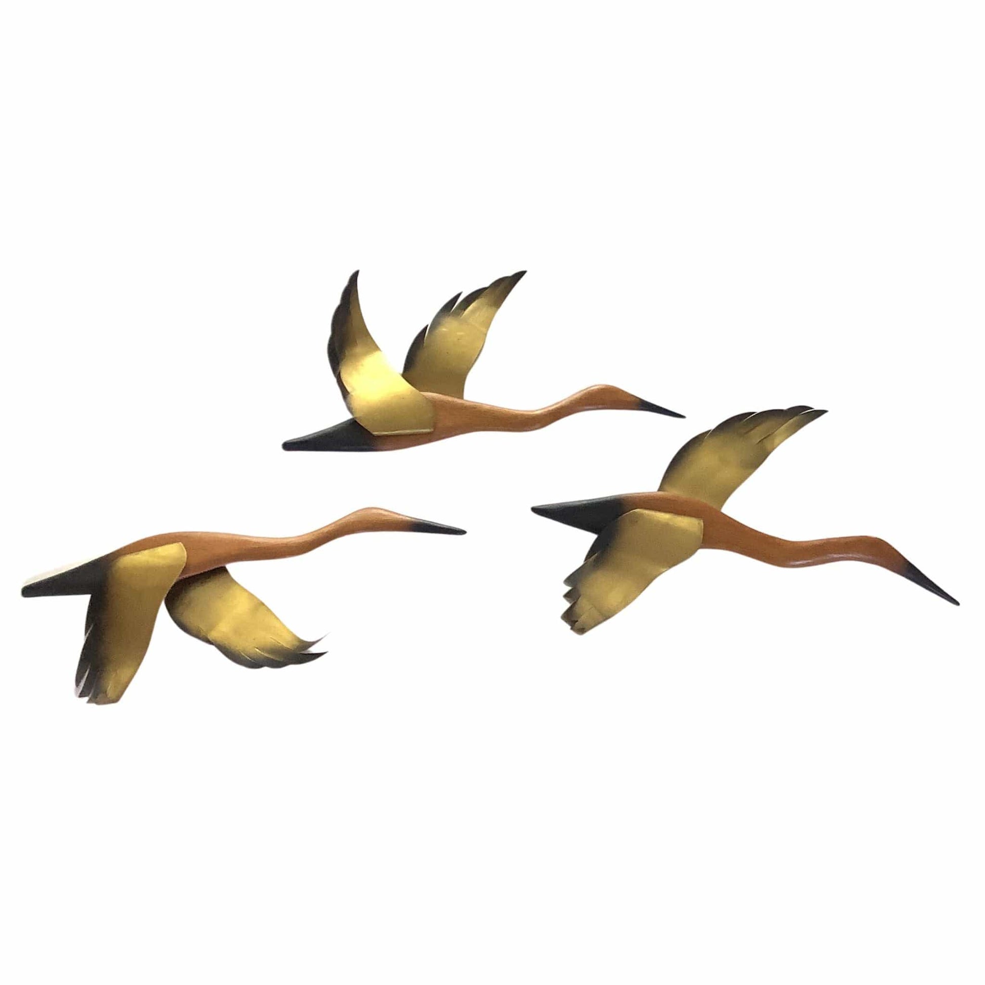 Three flying seagulls sculptures