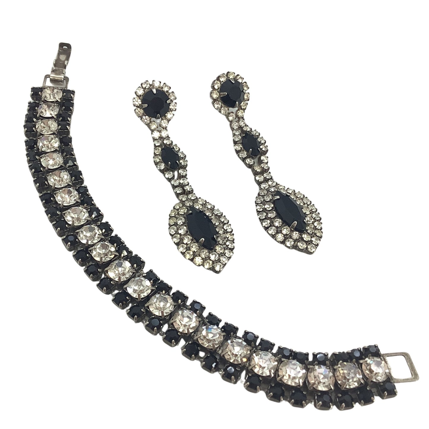 Jewelry set with a bracelet and earrings featuring black and silver crystals on a white background