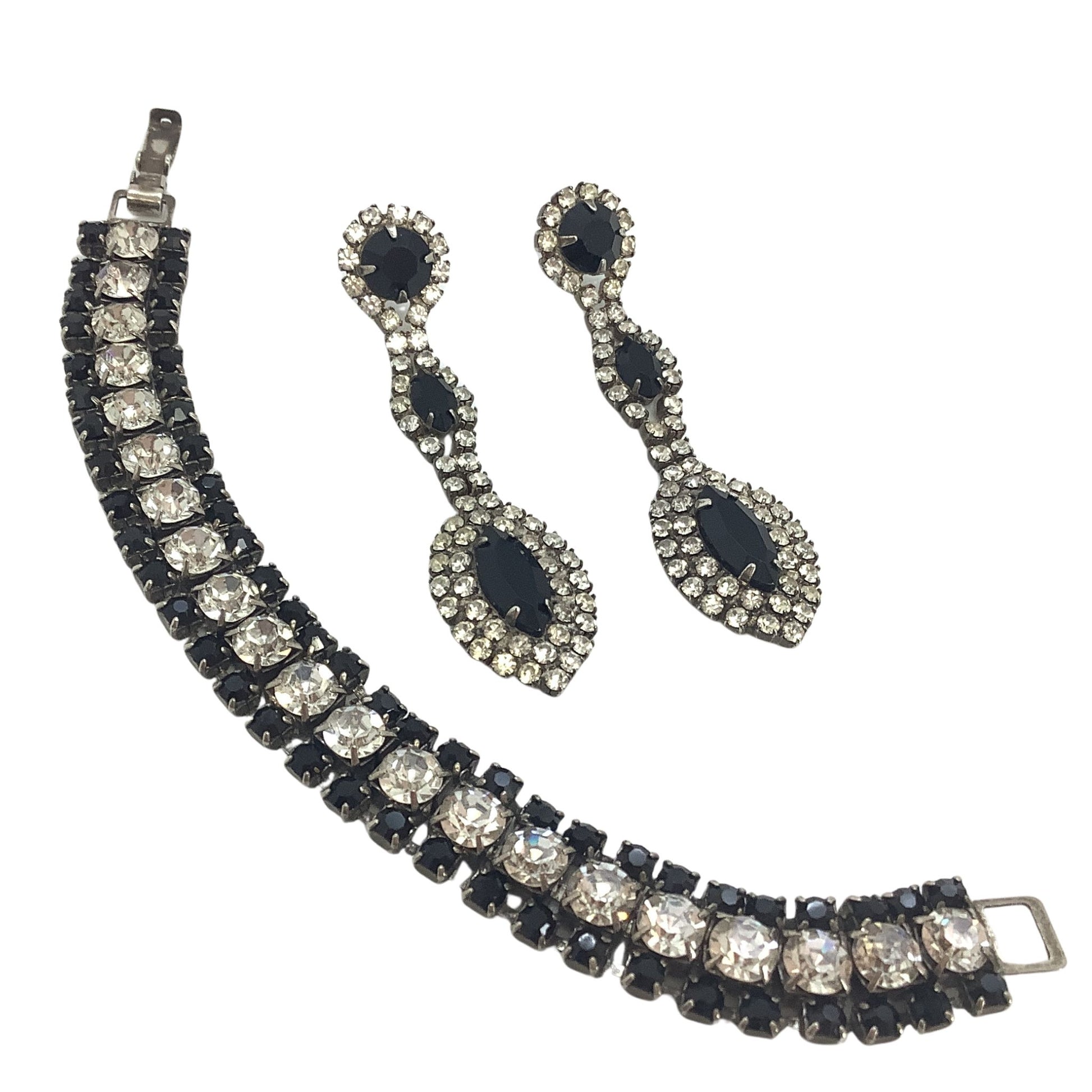 Jewelry set with a bracelet and earrings featuring black and silver crystals on a white background