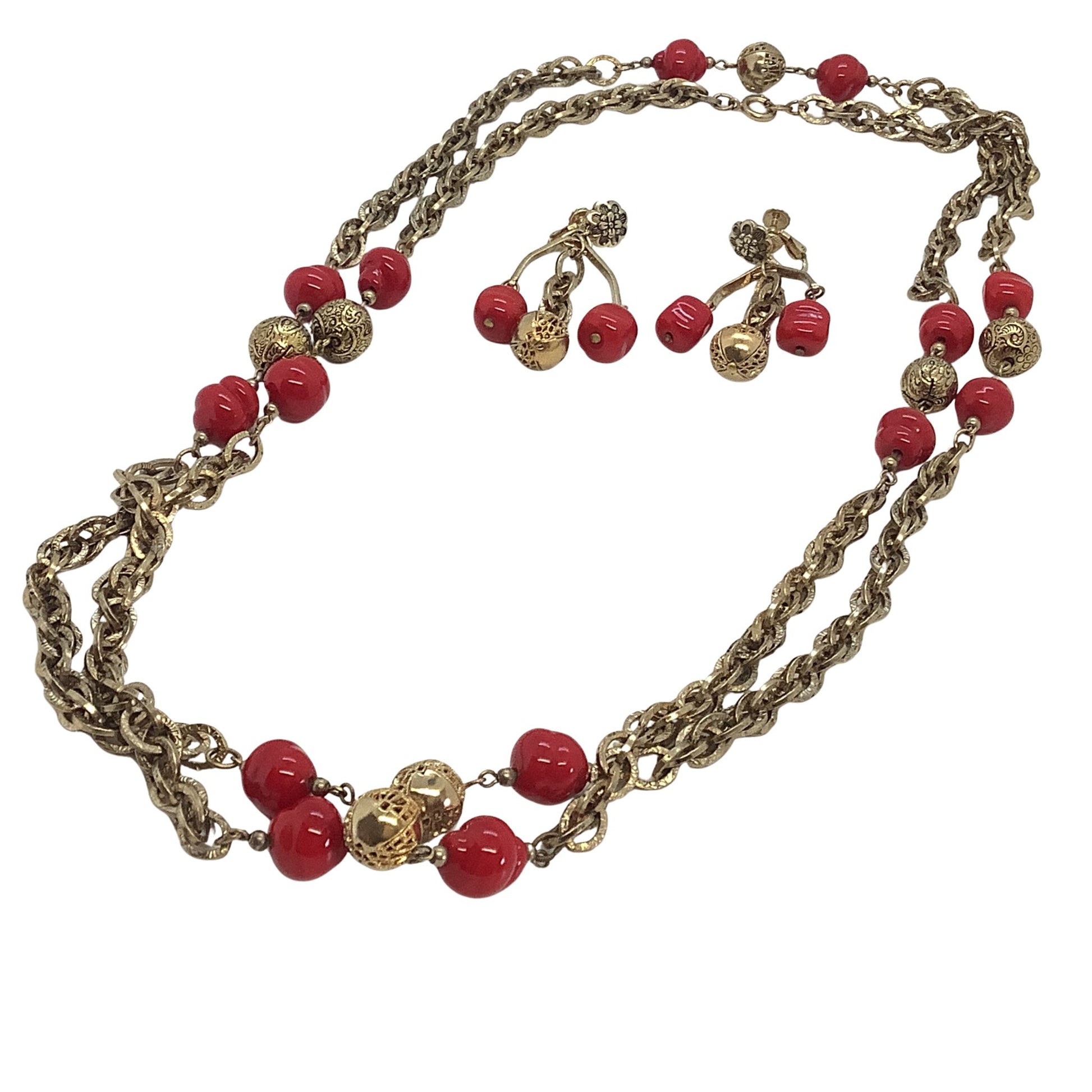 Necklace with red beads and gold chain on a white background