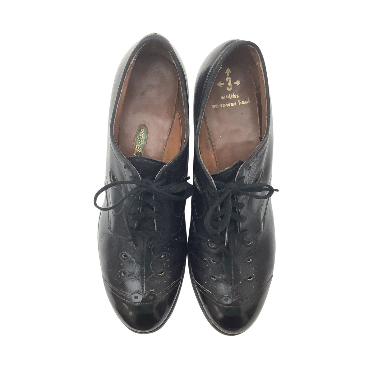 A pair of vintage Tread Easy black leather wingtip oxford shoes with black laces, shown from a top-down view on a white background. The insole shows the brand name 'Treadeasy'.