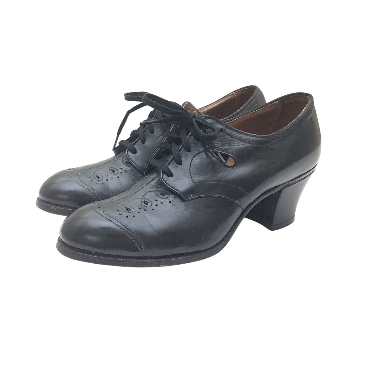 A pair of Tread Easy black leather lace-up oxford shoes with a low block heel and decorative brogue perforations on the toe, shown against a plain white background.