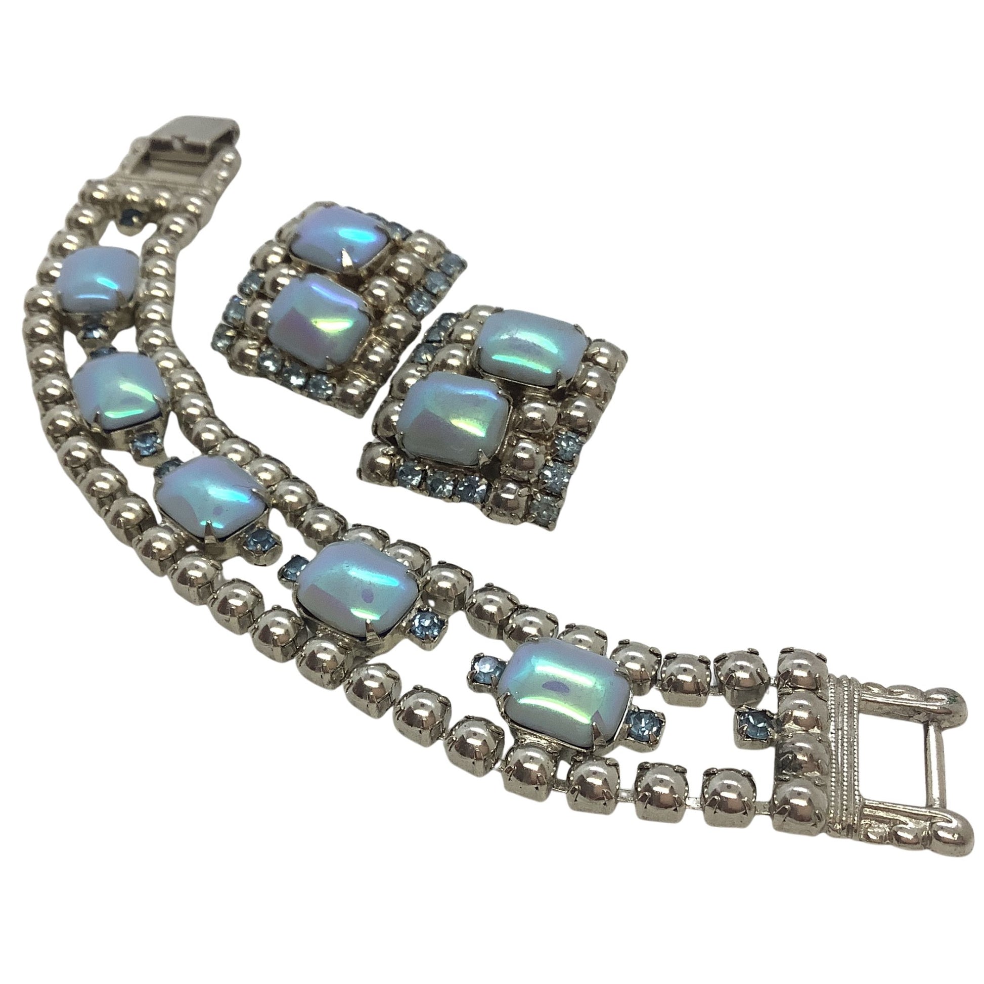 Jewelry set with blue moonstones and silver accents on a white background