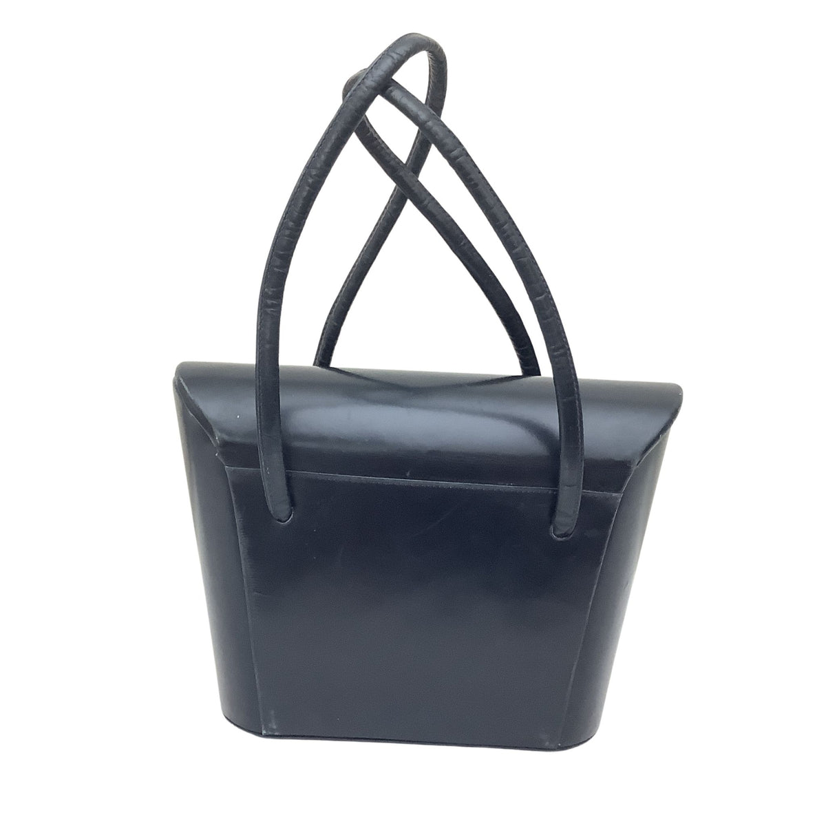 A navy leather handbag with a structured, sculptural body and two long, thin top handles that cross near the top, shown against a plain white background.