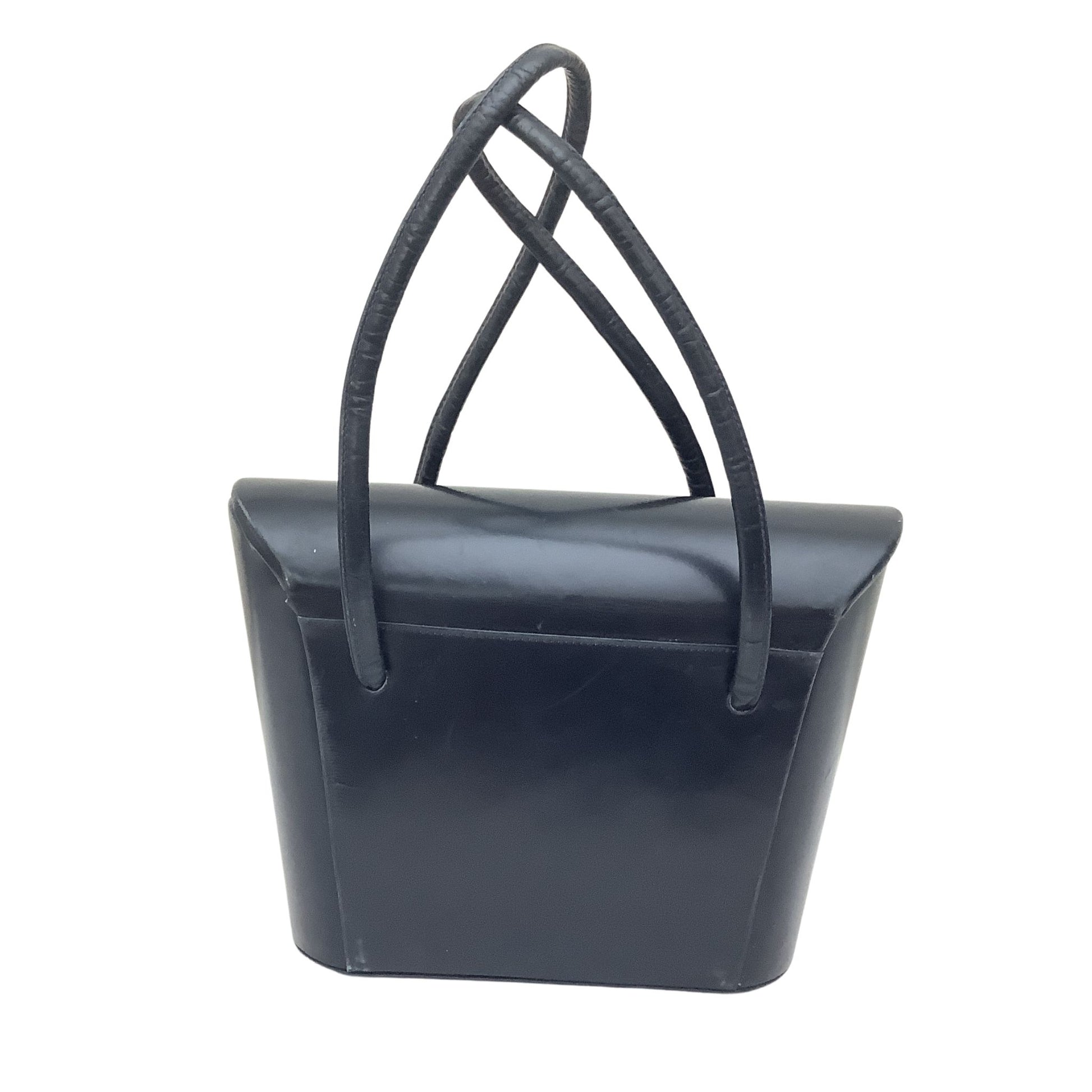 A navy leather handbag with a structured, sculptural body and two long, thin top handles that cross near the top, shown against a plain white background.