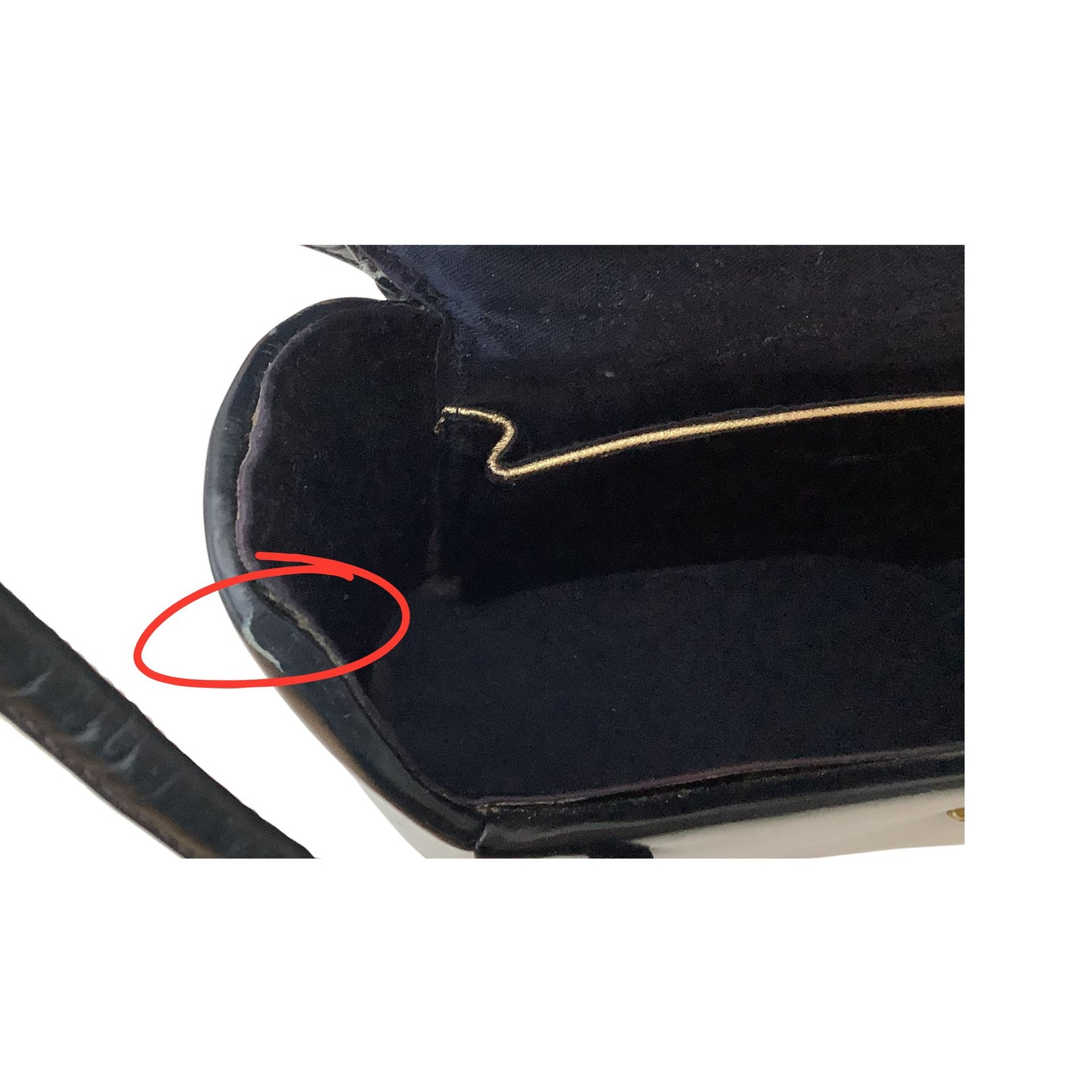 Close-up circled in red small tear in vintage purse