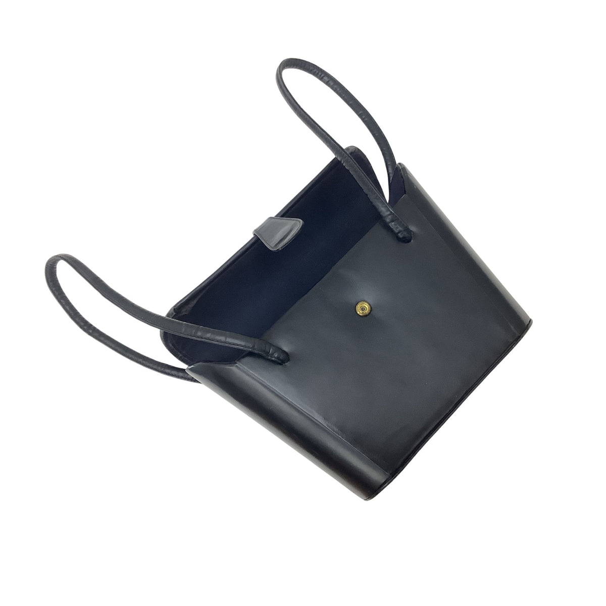 A navy leather vintage handbag with a structured rectangular shape, dual top handles, a small gold snap button on the front, and a dark blue interior lining.