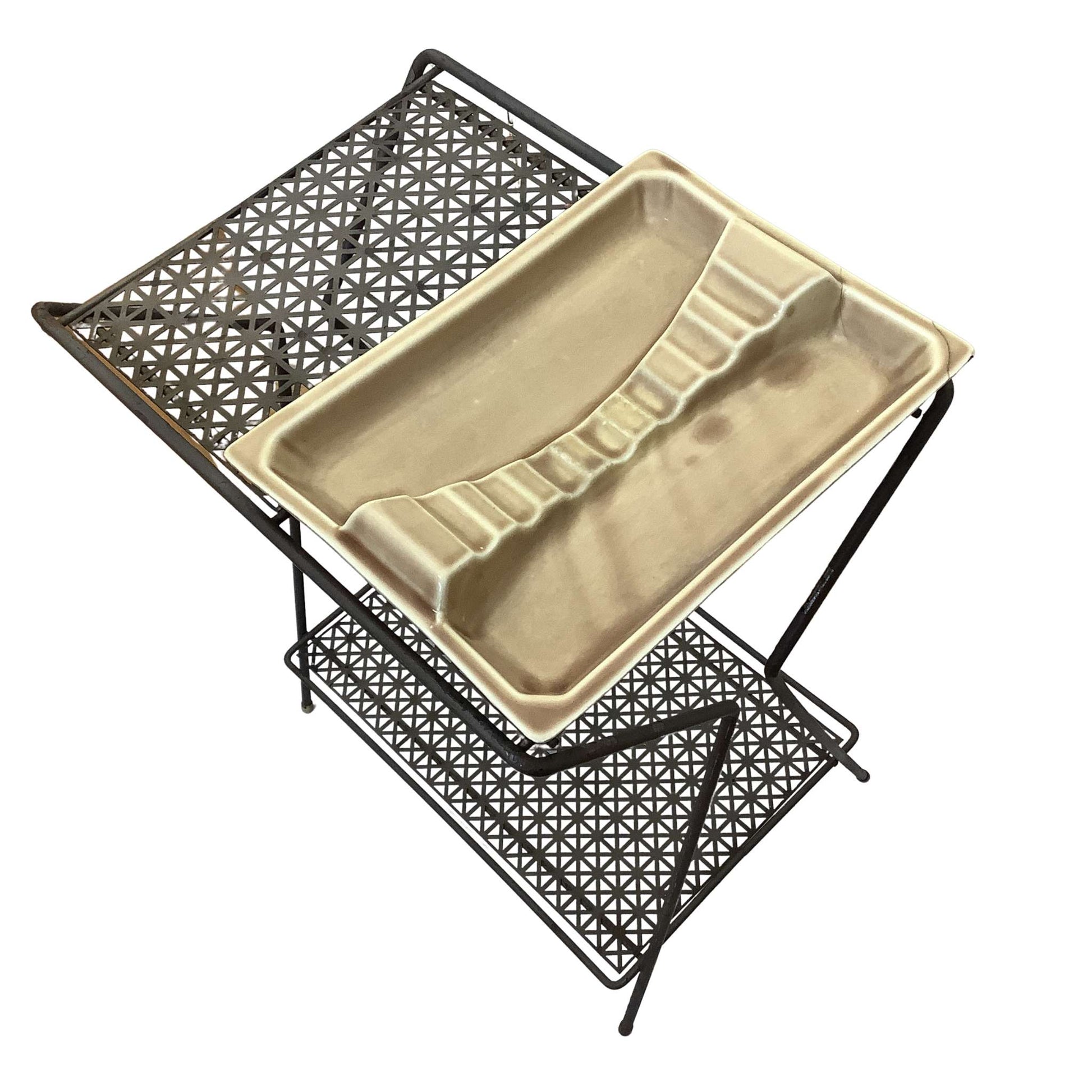 Beige ceramic ashtray on a black metal stand with geometric pattern on a white background