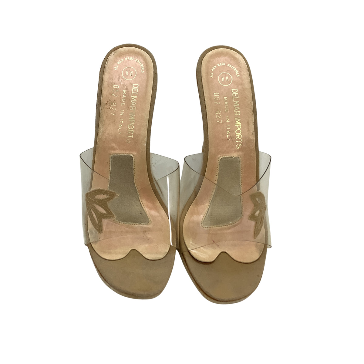 Vintage 1950s pair of women's slide sandals with clear transparent straps and branded label footbed, shown from a top-down view