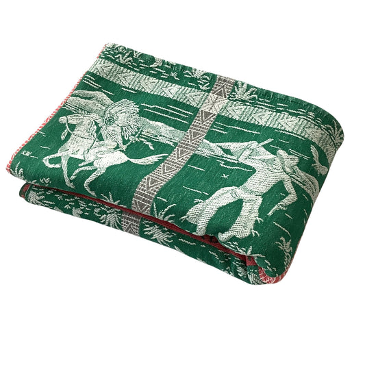 Folded vintage western bedspread in green and white with red accents.