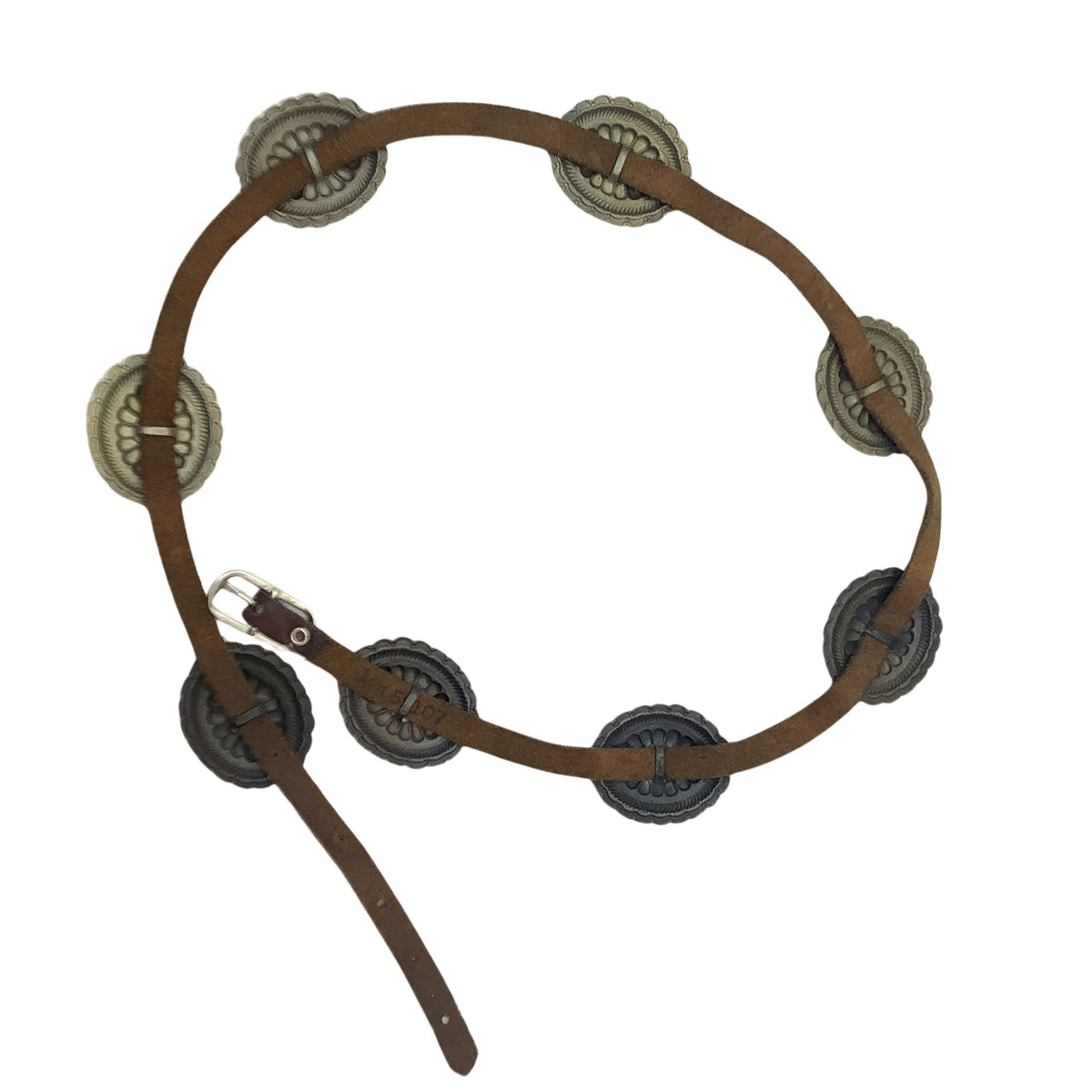 A brown leather belt with circular metallic conchos and a silver buckle, arranged in a loose circle on a white background.