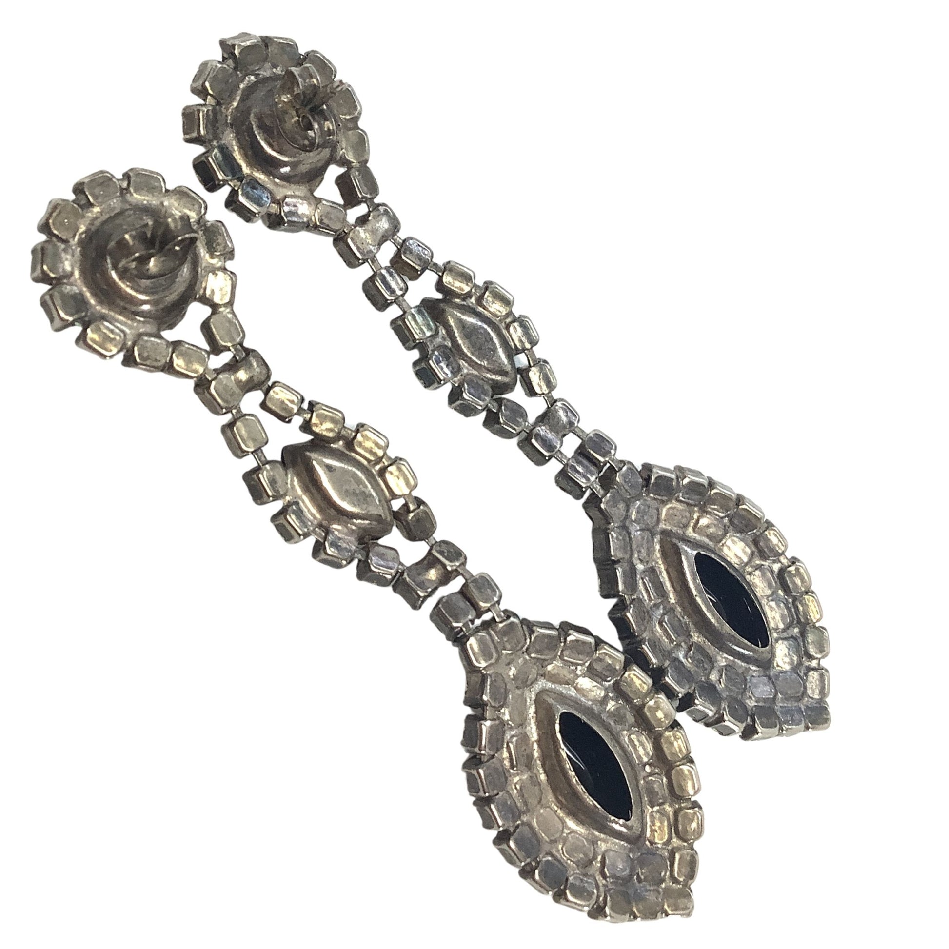 Back view of earrings silver-tone with black stones on a white background