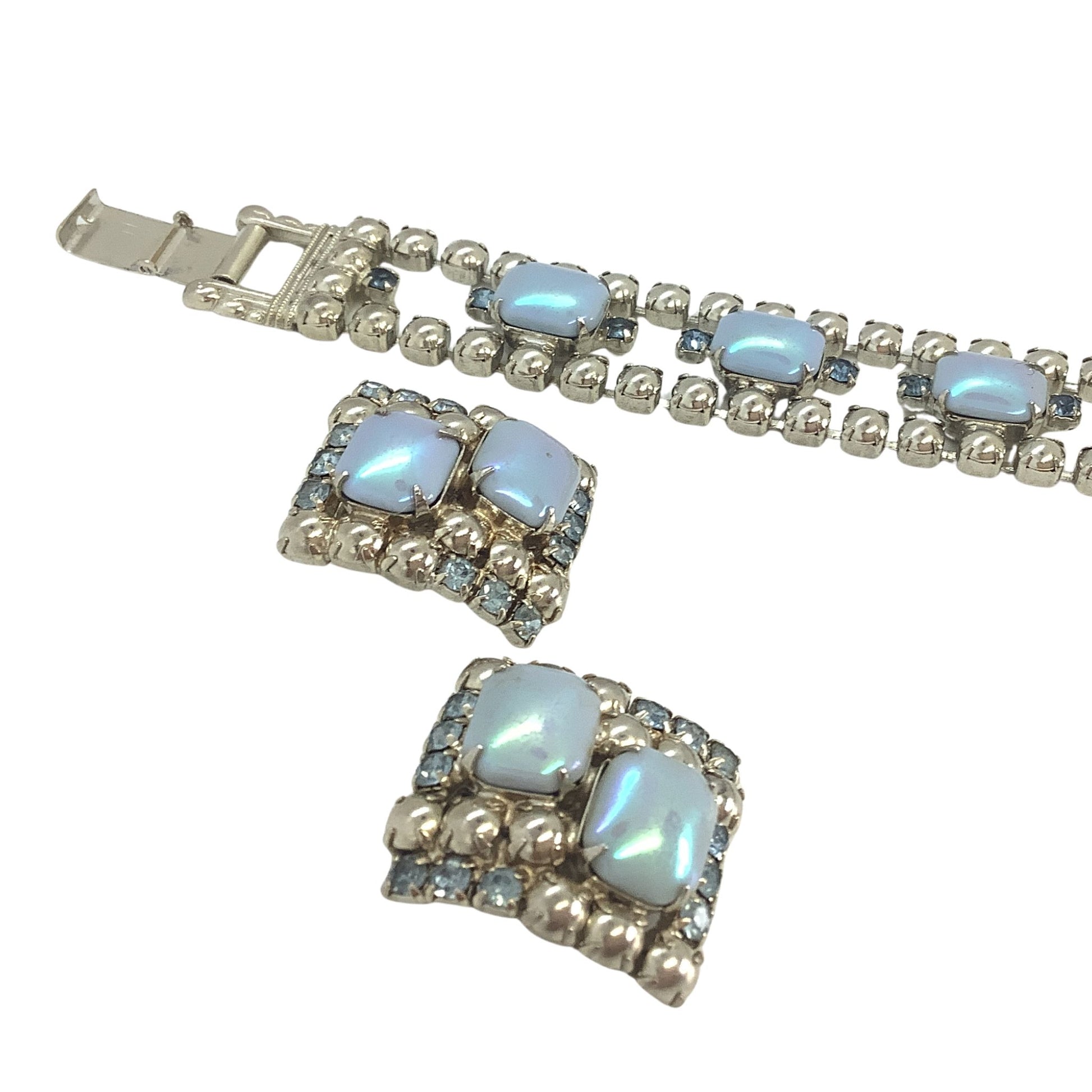 Silver bracelet with light blue gemstones on a white background