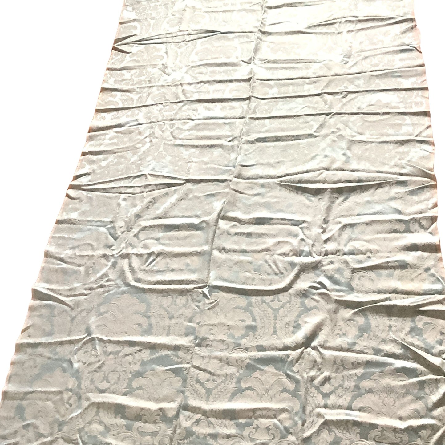 Overview of a long rectangular piece of blue and white satin brocade fabric