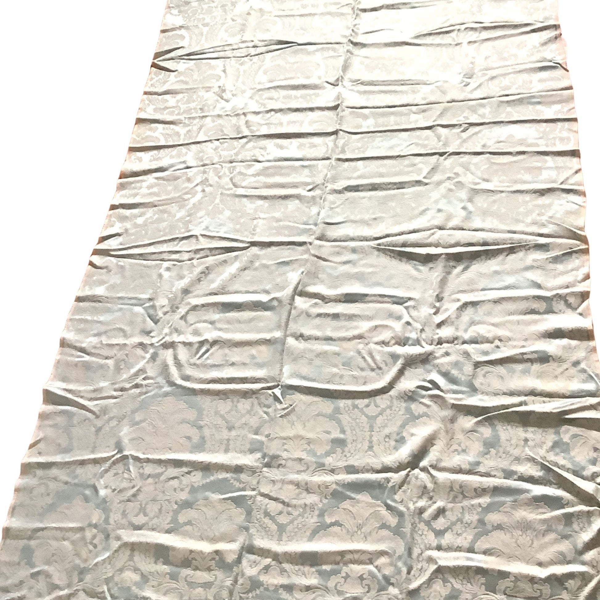 Overview of a long rectangular piece of blue and white satin brocade fabric