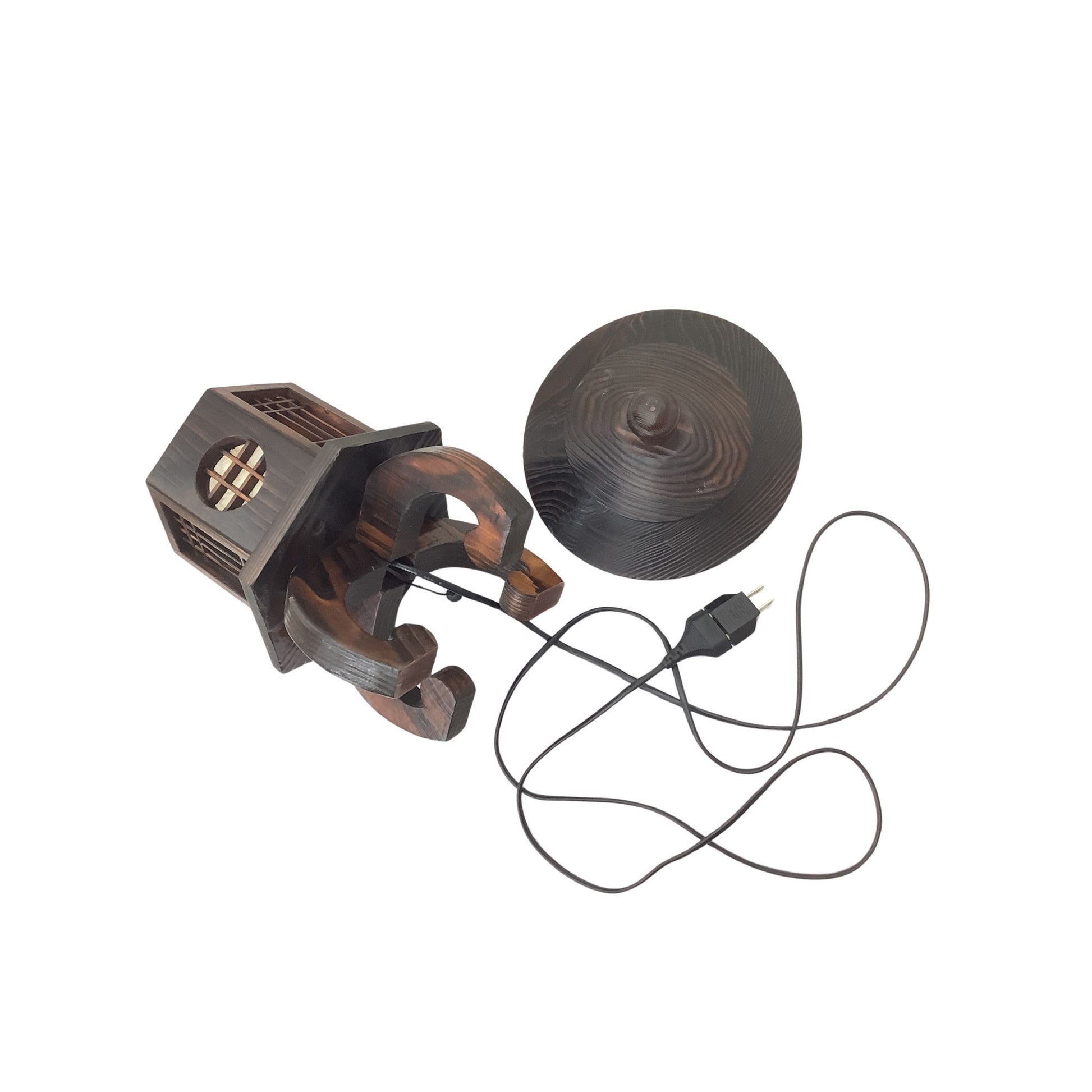 A dark brown wooden decorative lamp shaped like a traditional lantern, shown next to its matching conical roof accessory and a black power cord on a plain white background.