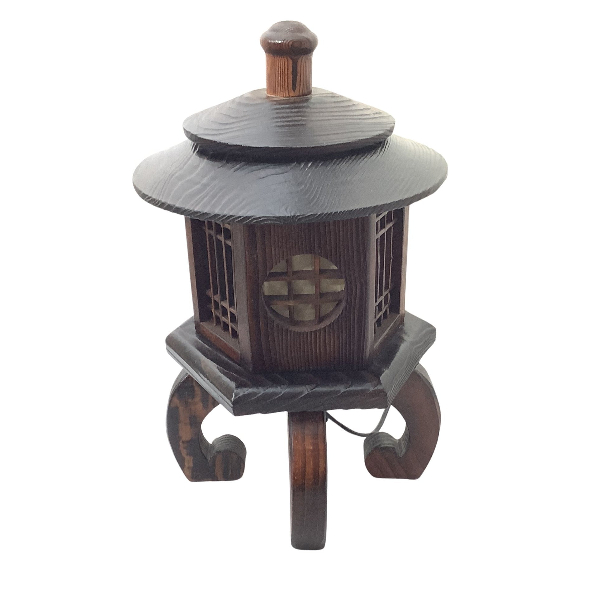 A dark brown wooden decorative lantern with a tiered roof, curved legs, and a circular window detail, isolated on a white background.