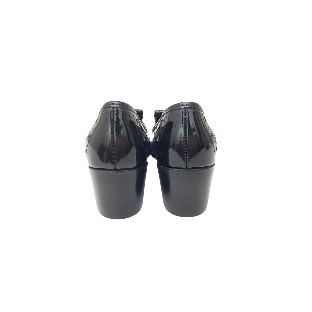 Black patent leather block-heel shoes shown from the back, featuring glossy patent finish and stacked block heels, set against a plain white background.