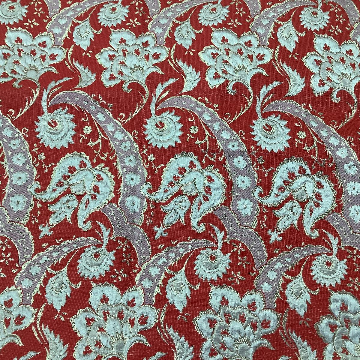 Close up of gold and red metallic brocade fabric.