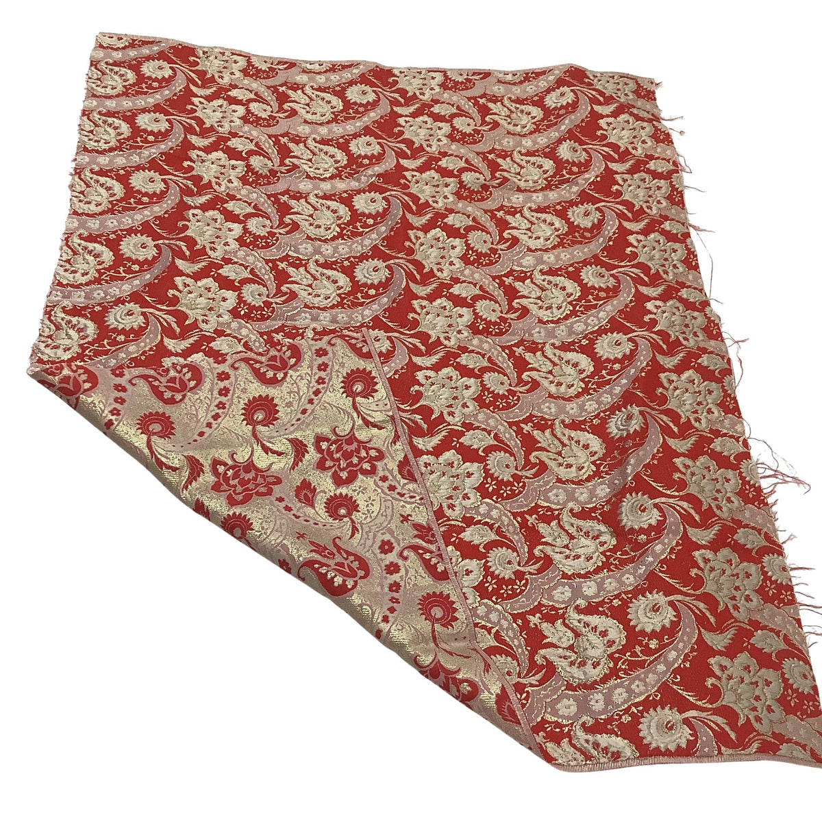 Vintage metallic gold and red brocade fabric with folded corner.