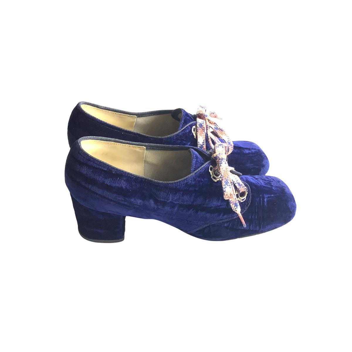 Side view of a pair of blue velvet comen's shoes with decorative shoelaces on a white background
