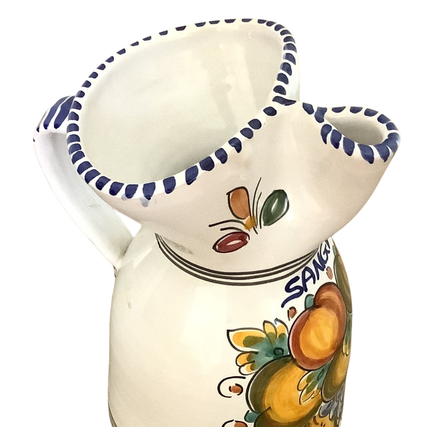 Hand-painted ceramic sangria pitcher detail view with fruit motifs on white background