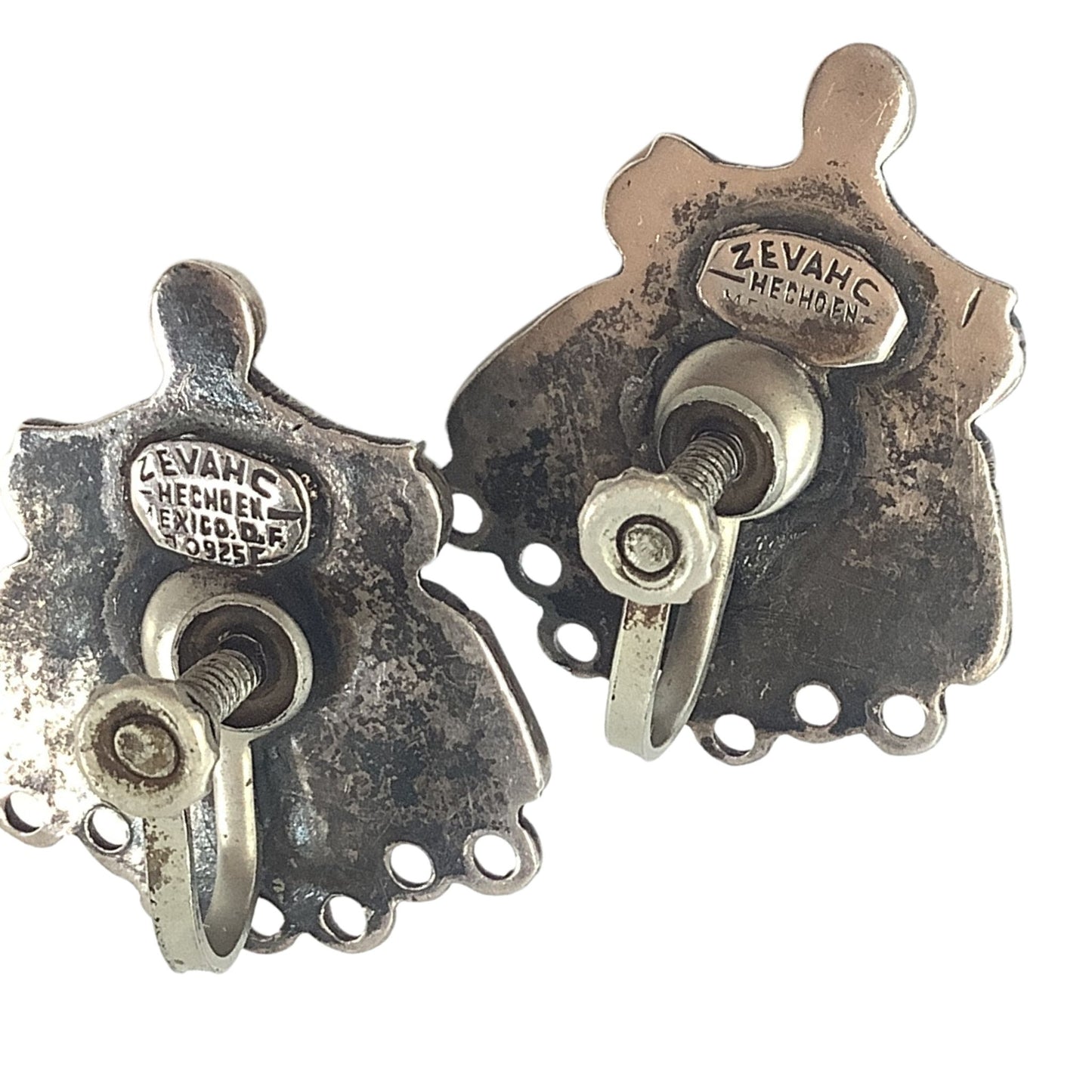 Vintage southwestern earrings detail on a white background