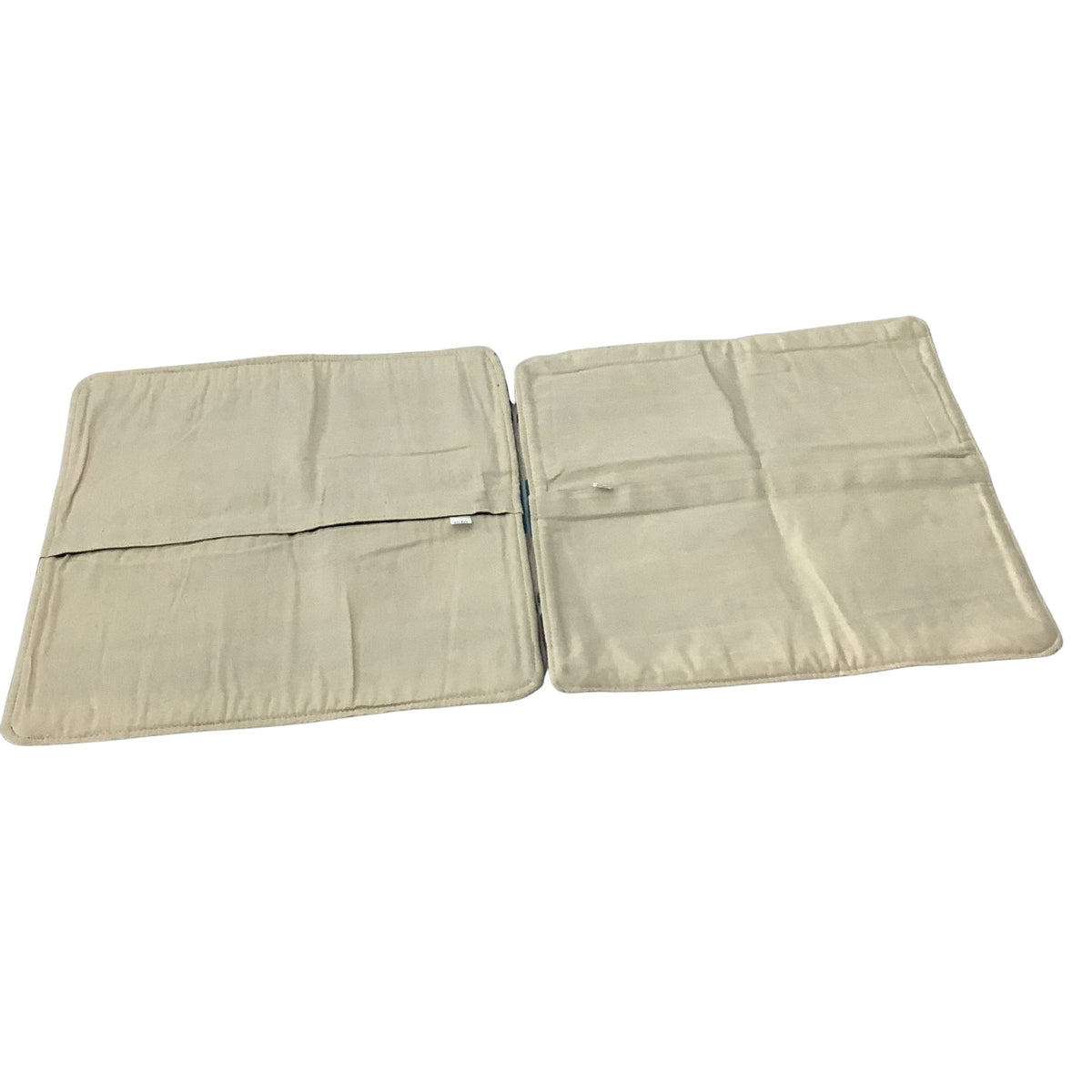 Back view of two matching Southwestern pillow covers with beige cotton fabric