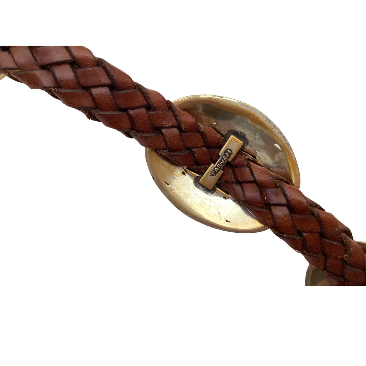 A close-up of a brown braided leather belt with a large oval gold-toned metal Concho and a small rectangular brand tag reading 'Taiwan' on a white background.