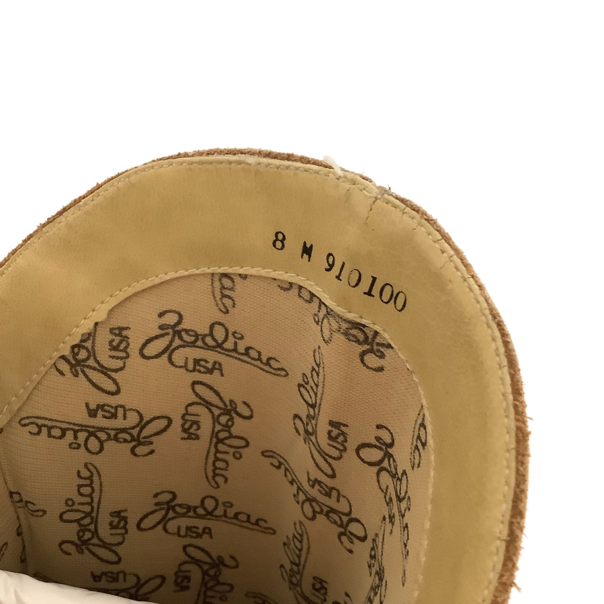 Close-up of the interior of a boot, showing the printed Zodiac USA pattern, size marking '8 M'