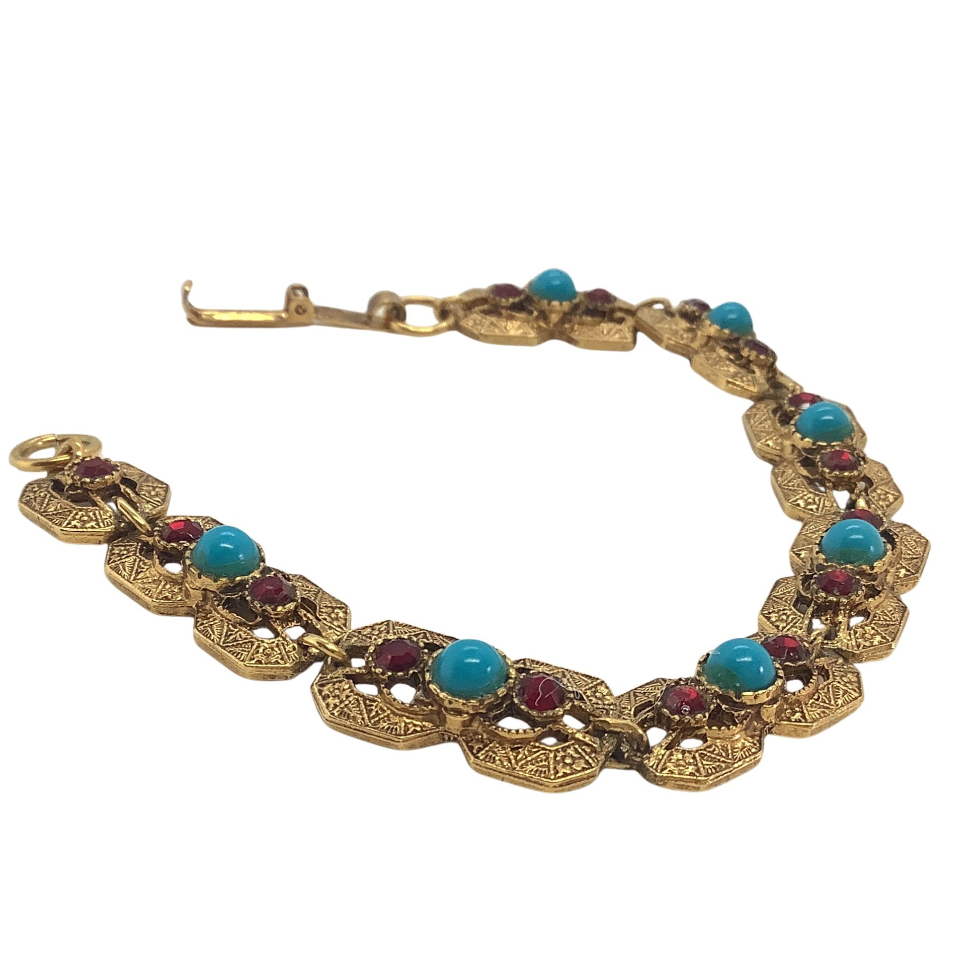Western style bracelet with turquoise and coral colored stones on a white background
