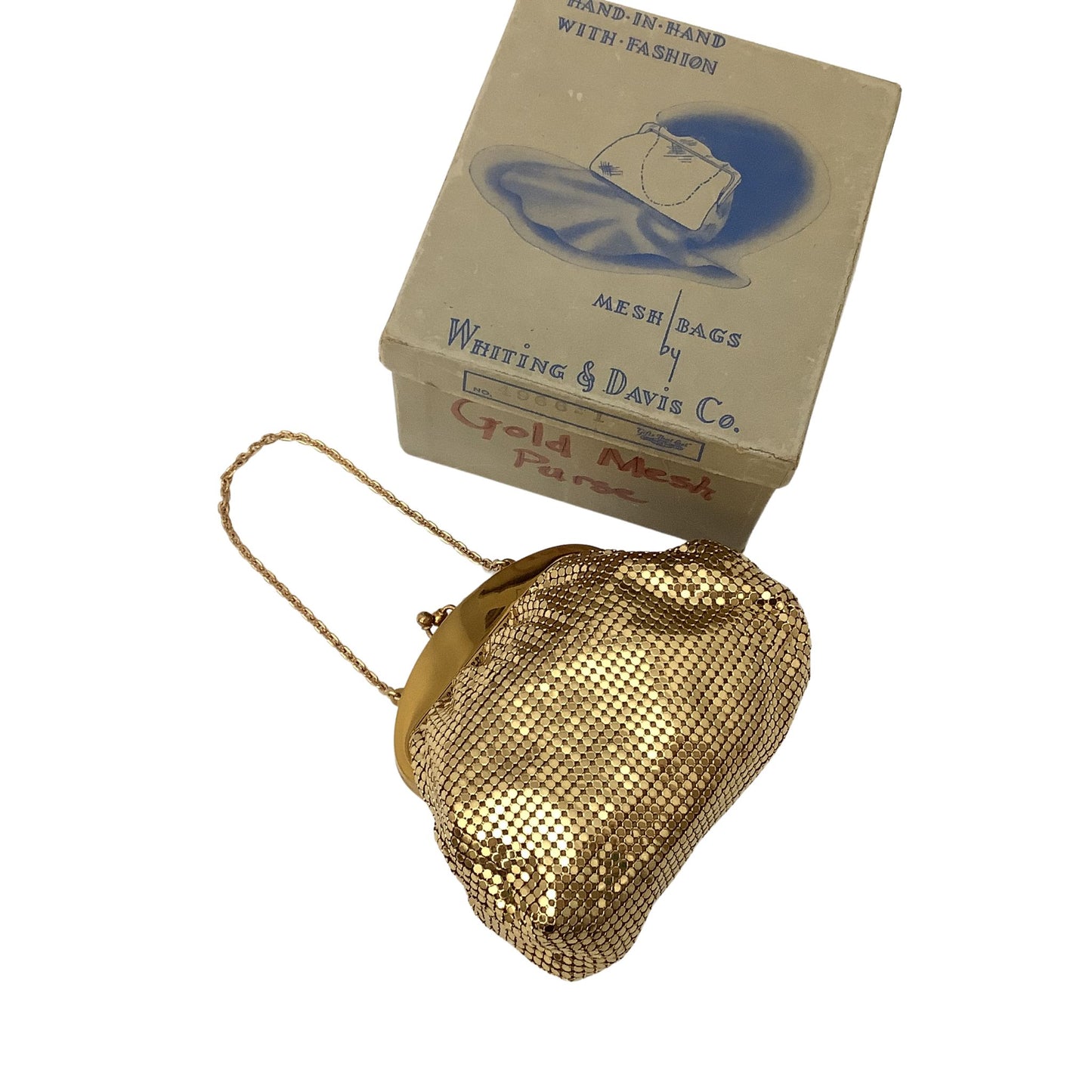 A vintage Whiting & Davis gold mesh purse with a gold-tone chain strap, displayed next to its original cardboard box by Whiting & Davis Co.