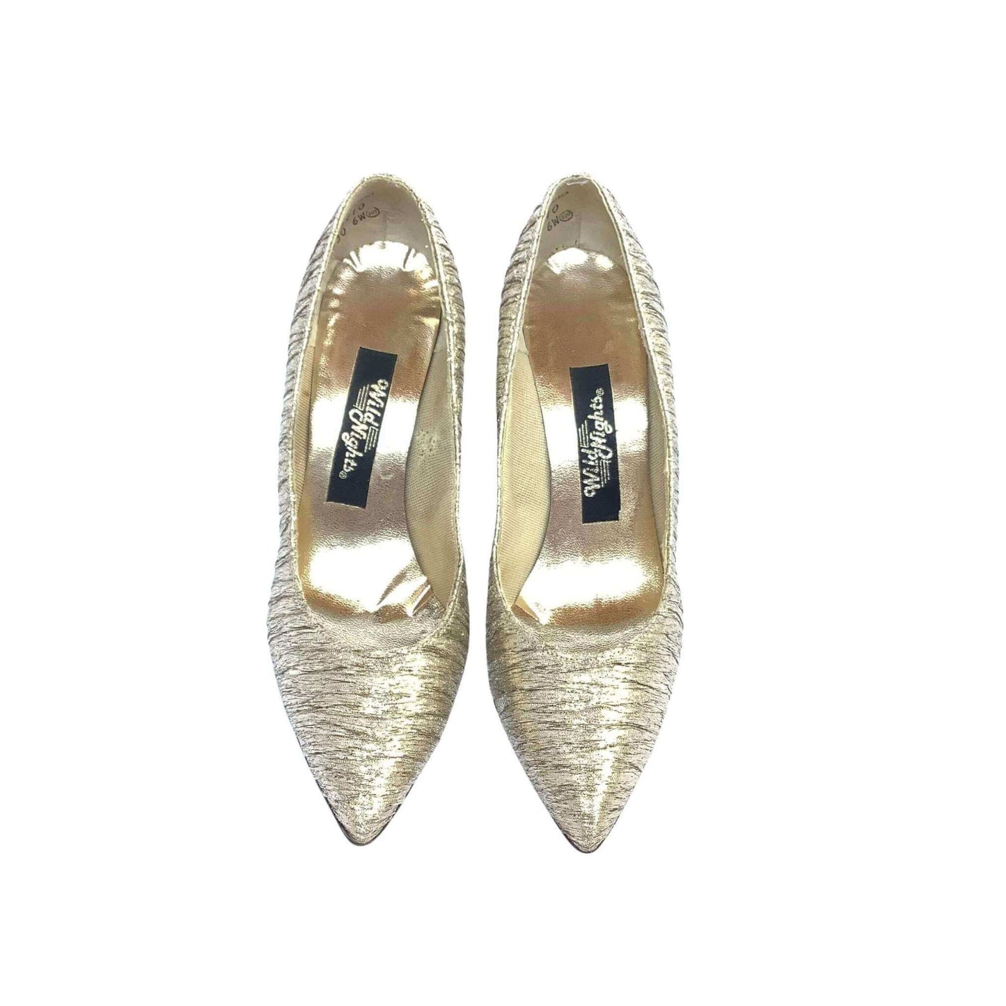 Pair of Wild Nights gold high-heeled pumps top view on a white background